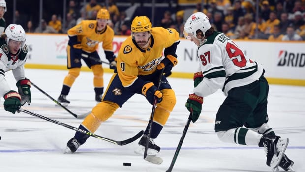 Nov 15, 2022; Nashville, Tennessee, USA; Nashville Predators left wing Filip Forsberg (9) skates with the puck against Minnesota Wild left wing Kirill Kaprizov (97) during the first period at Bridgestone Arena. Mandatory Credit: Christopher Hanewinckel-USA TODAY Sports